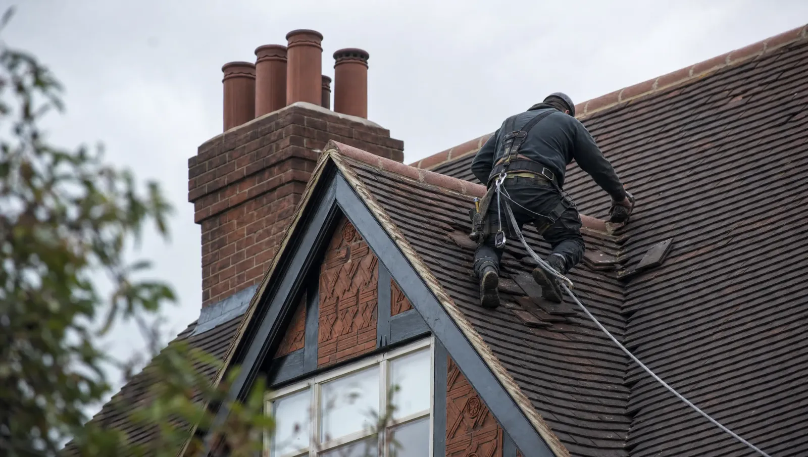 Professional roofer working safely on a Worcestershire house