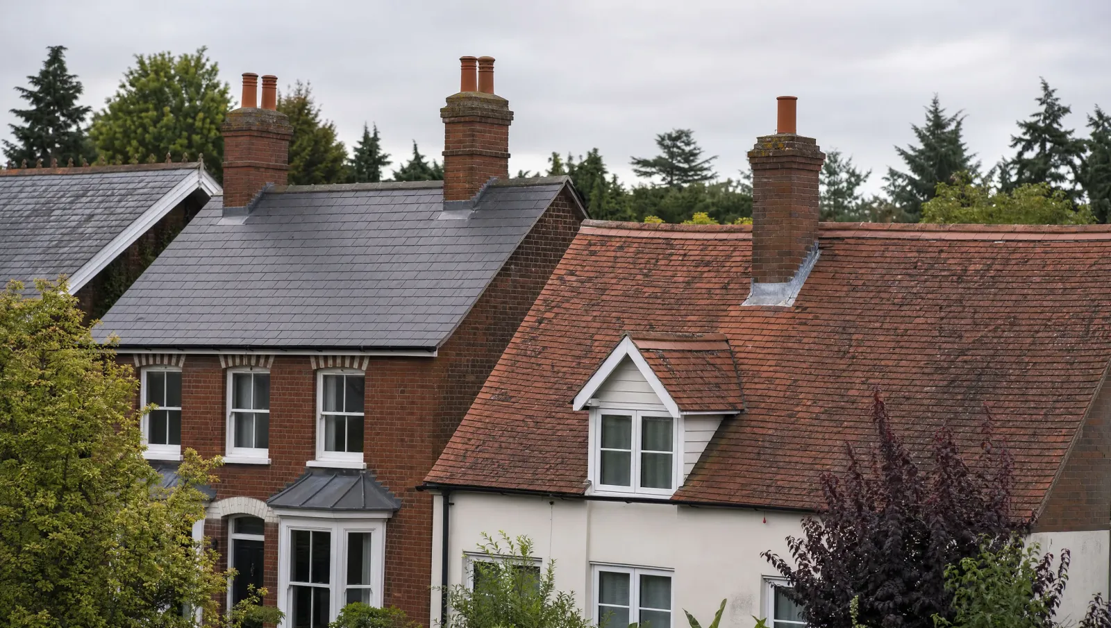 Slate and clay tile roofs on neighbouring British homes