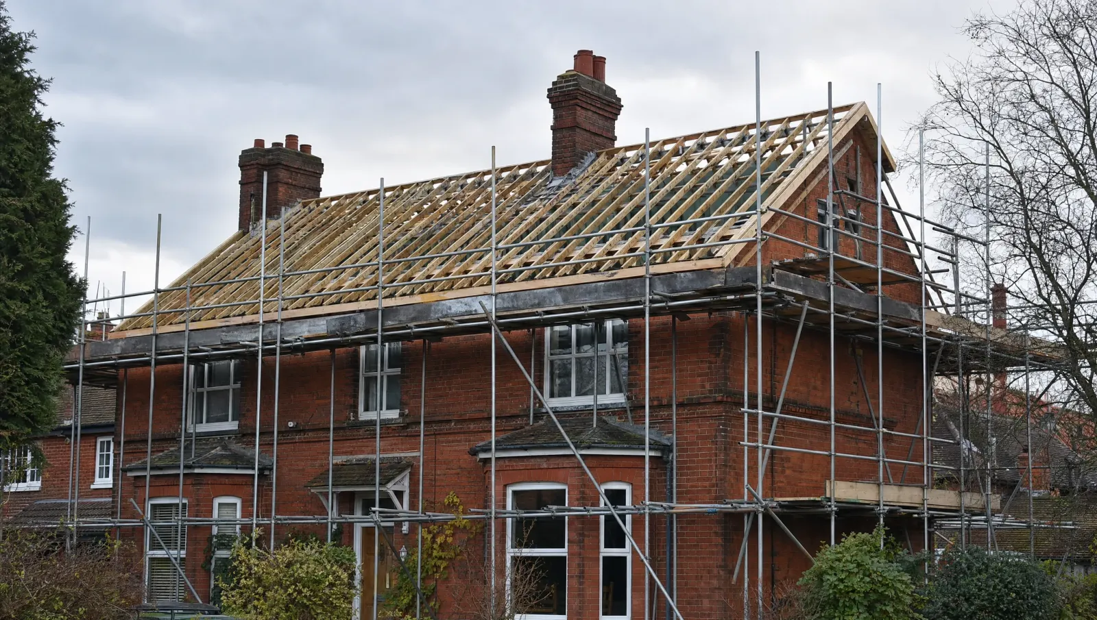 Scaffolded British house prepared for roof replacement